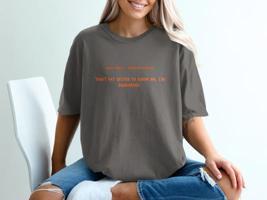 Dark grey t-shirt with orange text: "DATA_FAULT // INJECTION_REJECTED. DON'T GET EXCITED TO KNOW ME, I'M DANGEROUS."